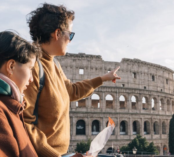 A mother is explaining the history and significance of the Roman Colosseum to her daughter