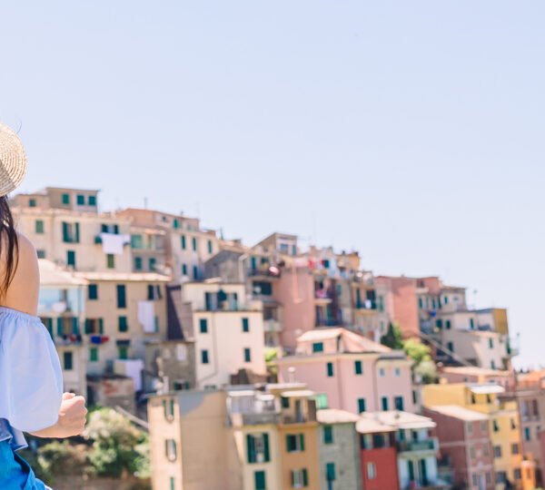 Panorama of old village in Liguria and young family enjoying summer vacation