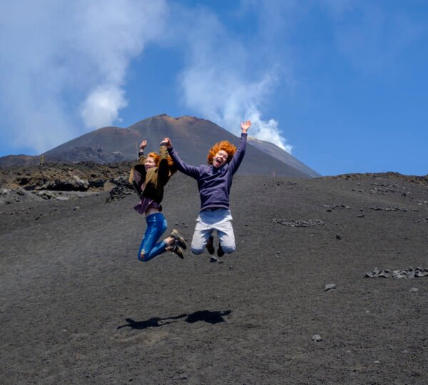 Italy, Sicily, Mount Etna, Teenager jumping in the air